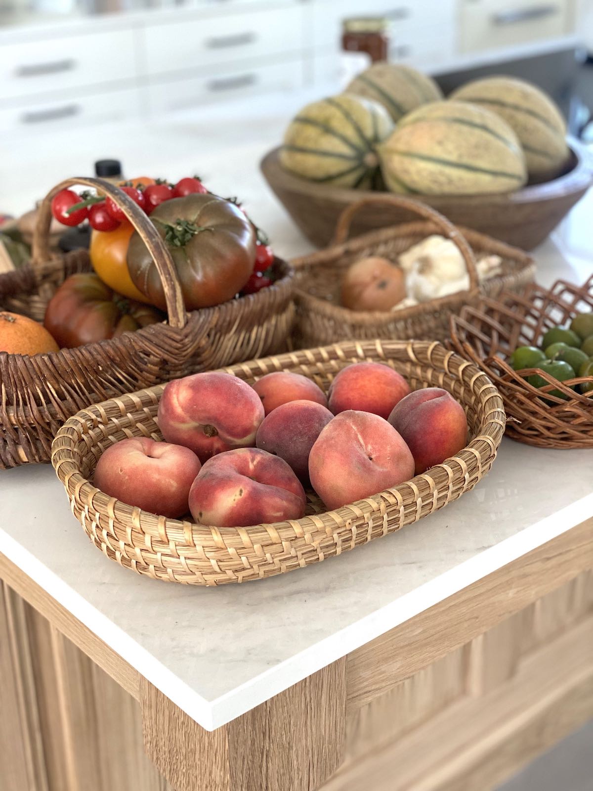 Fresh fruits and vegetables in baskets on a counter