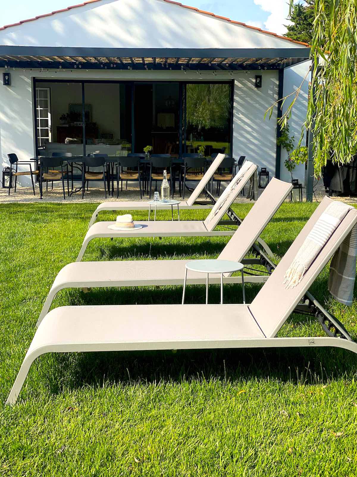 Lounge Chairs lined up with house in the background