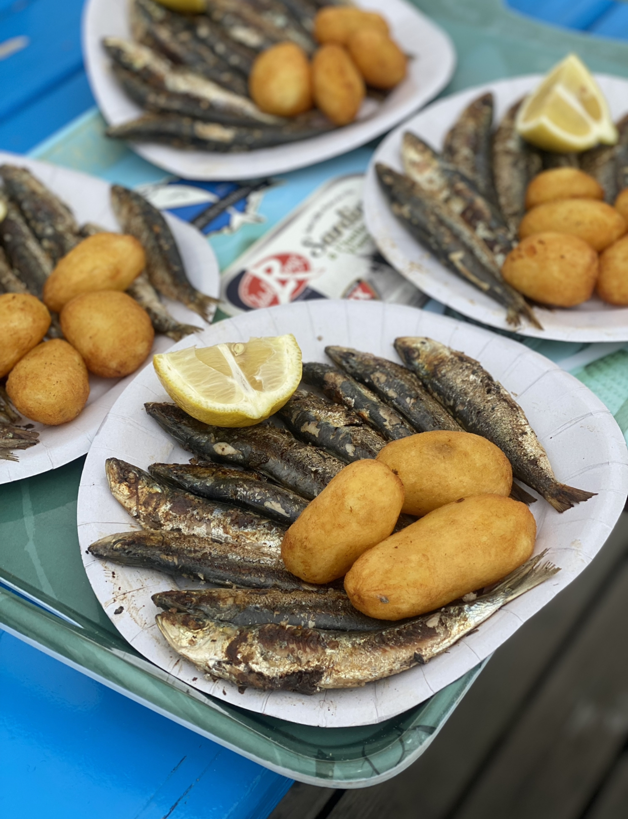 Plates of sardines and potatoes